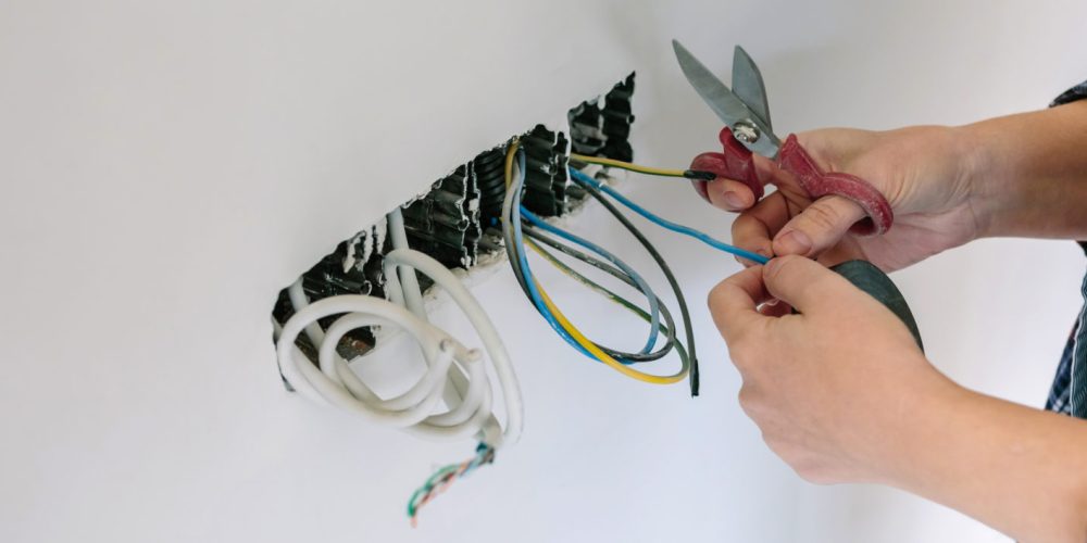 Unrecognizable female electrician working on the electrical installation of a house